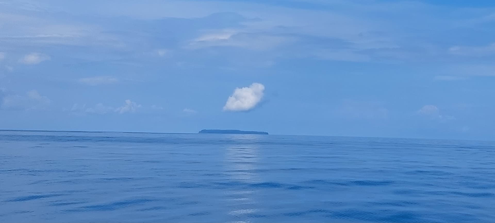 Caño Island seen from the boat across calm blue waters