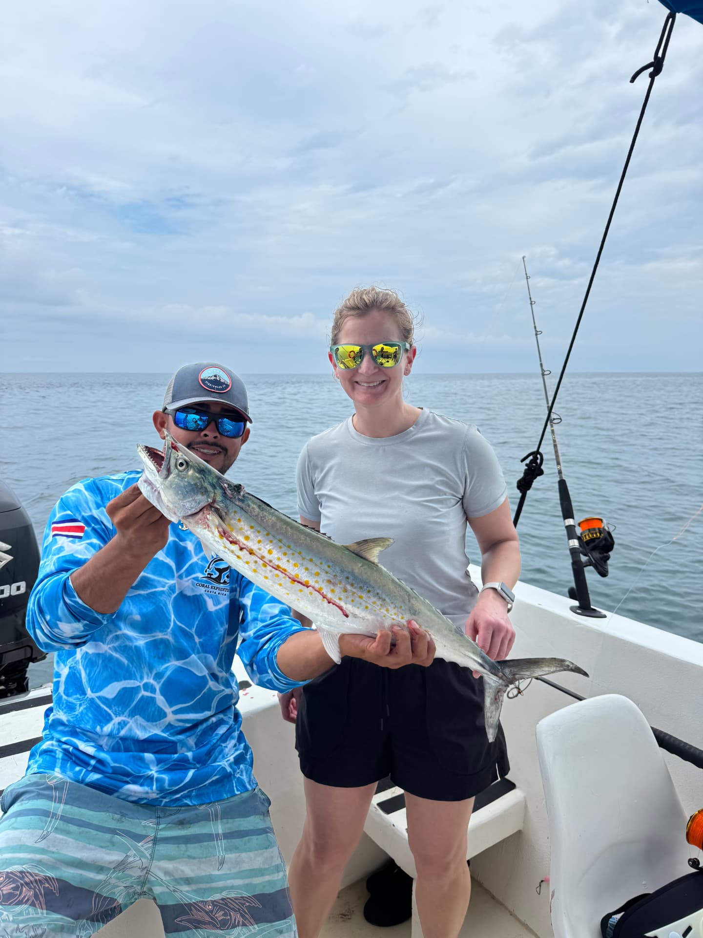 Angler and guide holding a sierra mackerel on the boat