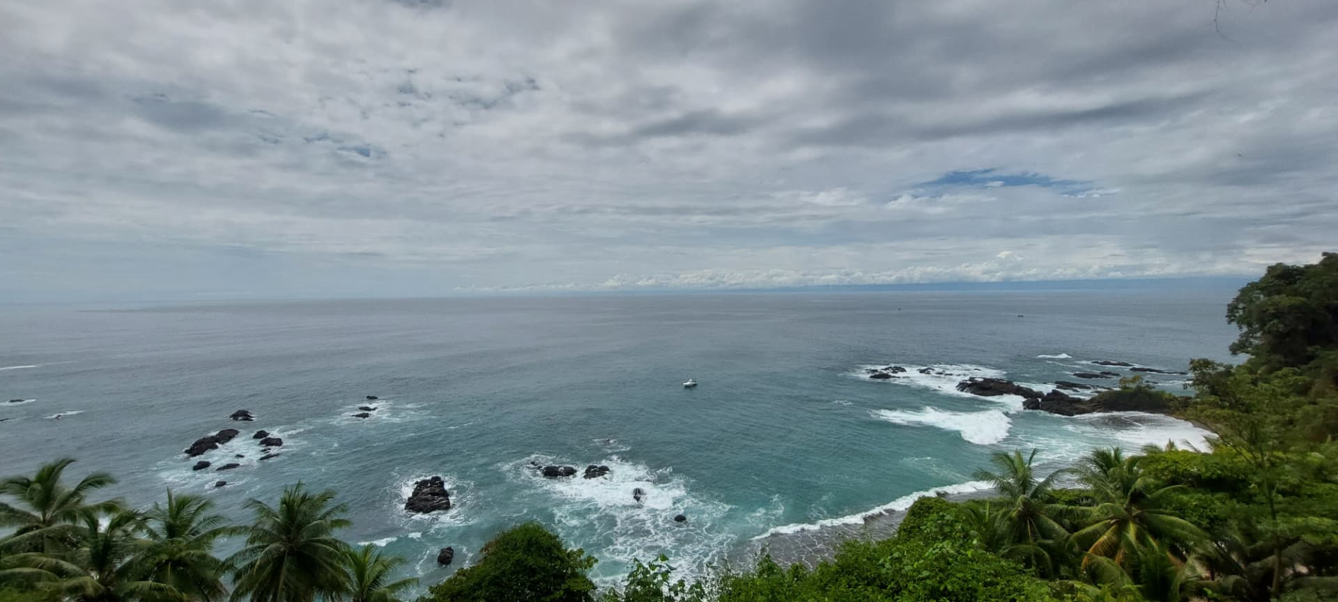 Lookout over the rocky coast and turquoise waters of Caño Island