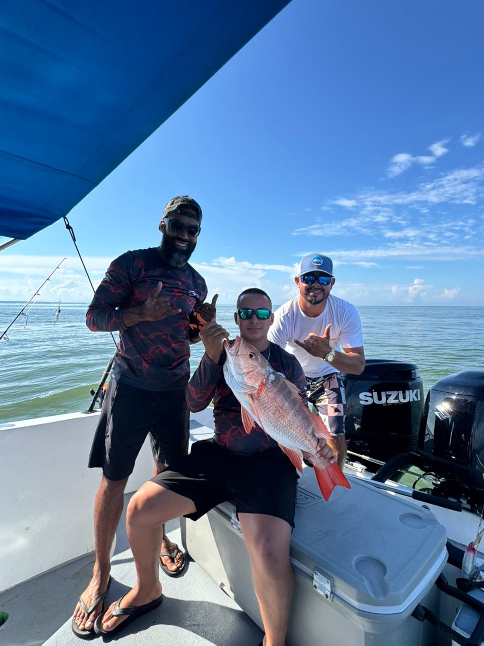 Group of anglers with a snapper on the boat